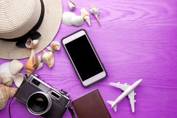 Summer holiday background, travel concept with camera and mobile phone
 on wooden table background