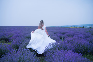 Young girl in white dress in lavender field