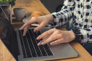 Young woman work using laptop in a coffee shop