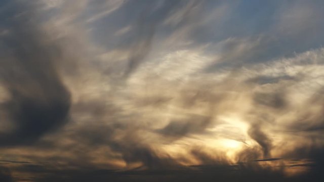 The evening sky with flying clouds. A lot of insects and dust fly in the air. Time-lapse