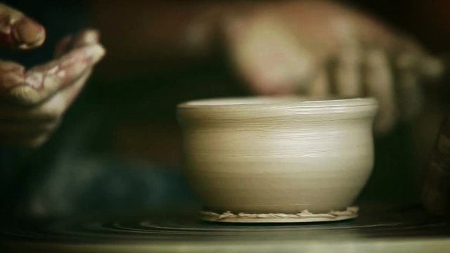 Process of the making of a clay cup in a traditional way on a potter's wheel