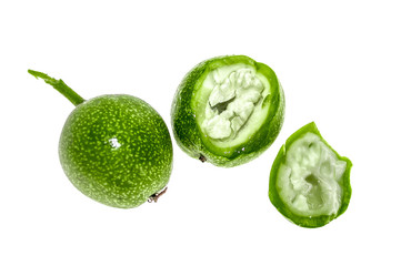 Green walnut fruit on a white background