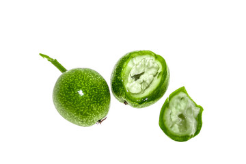 Green walnut fruit on a white background