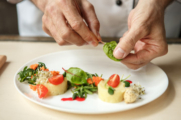  Mature man professional chef cooking meal indoors
