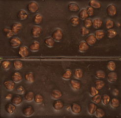 Chocolate background. Milk chocolate with hazelnuts close-up.