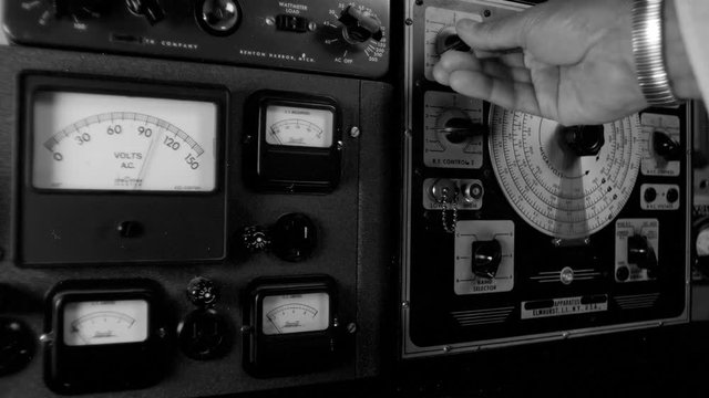 VINTAGE RADIO EQUIPMENT BEING ADJUSTED