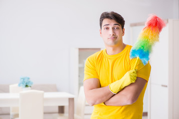 Young man doing chores at home
