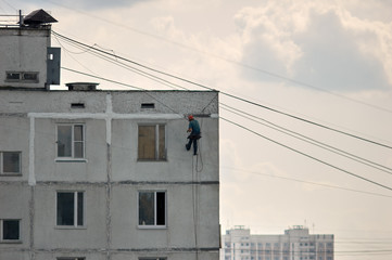 Fototapeta na wymiar Industrial climber on building