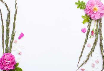 Romantic flower flat lay frame with roses, jasmine, carnation, daisies and lupines