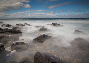 Long time exposure of waves around rocks at the Wild Coast at the Indian Ocean in South Africa