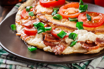 Omelette with bacon and tomatoes
