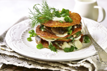 Draniki -potato pancakes with mushrooms and cream sauce.