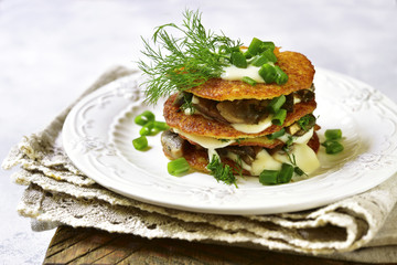 Draniki -potato pancakes with mushrooms and cream sauce.