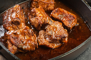 Pork spare ribs on dish in own sauce