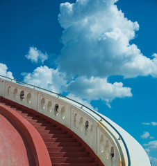 Stairs towards blue sky with clouds