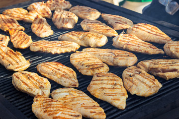 grilled chicken fillets on the barbecue. Street food.