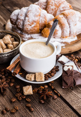Breakfast with coffee and croissants on table