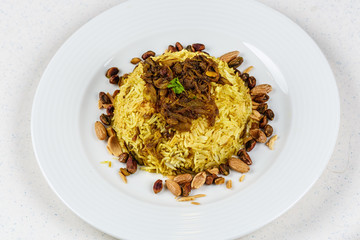 Traditional Middle Eastern fish and fried rice dish with fried pine nuts