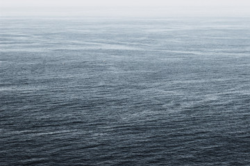 Shot of the vast Atlantic ocean, from the Northern coast of Spain, with boats far away