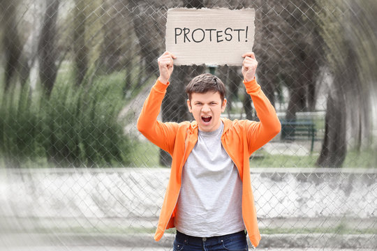 Young man with placard on workers strike outdoor