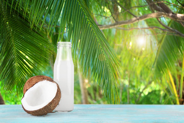 Bottle of coconut water and fresh nut on white background © Africa Studio