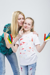 Family Ideas. Mother and Her LIttle Caucasian Blond Daughter Having Hand and Face Paint Time...