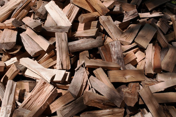 A large pile of cut wood before being stacked