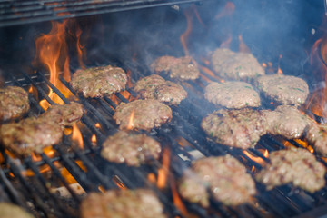 burgers on grill , beef on flaming barbecue grill  