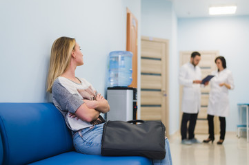 Woman Patient Waiting At Hospital Doctors Waiting Room