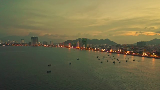 Drone Shows Evening City on Seaside against Sunset
