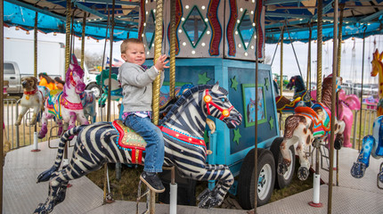 Fototapeta na wymiar Cash Cotton enjoying a ride on a semi-creepy carousel