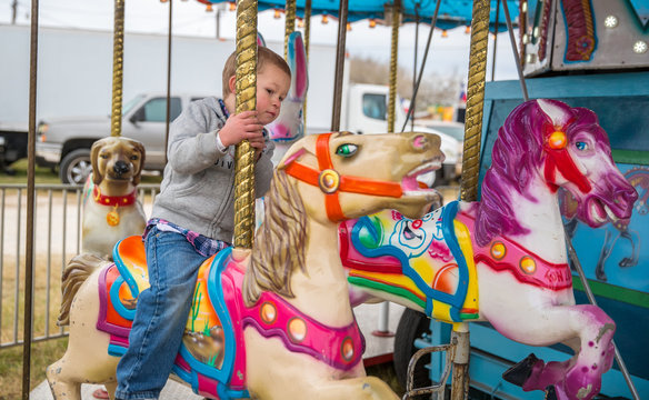 Cash Cotton enjoying a ride on a semi-creepy carousel