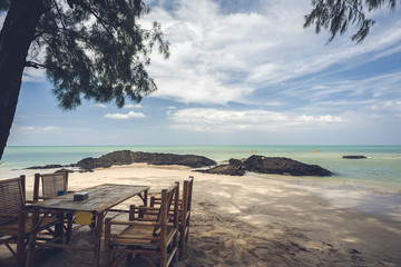 Bamboo table with beach on bright sky
