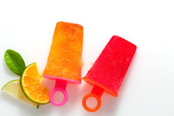 flat lay style of handmade ice cream with lime and orange fruit on white background.