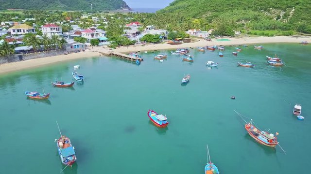 Flycam Moves over Azure Bay to Moderm City on Coast