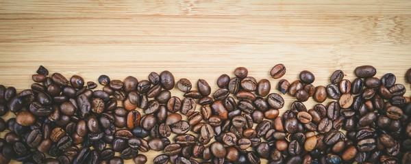 coffee beans on wooden table for background
