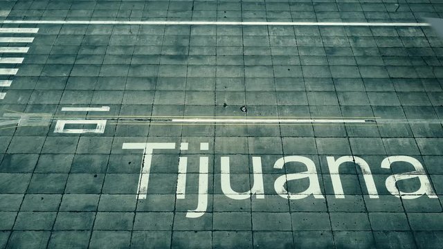 Aerial view of commercial plane landing at Tijuana airport. Travel to Mexico conceptual 4K intro animation