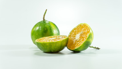 Tangerines and slices on the white background
