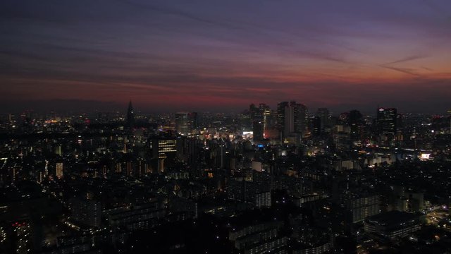 Japan Tokyo Aerial v73 Flying low over Shinjuku area panning with cityscape views at night
