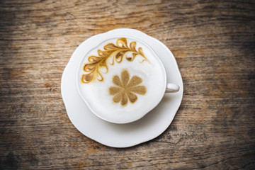 Latte coffee on old wood table.