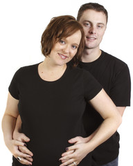 Fototapeta premium a young couple in studio with man behind holding wife's belly 