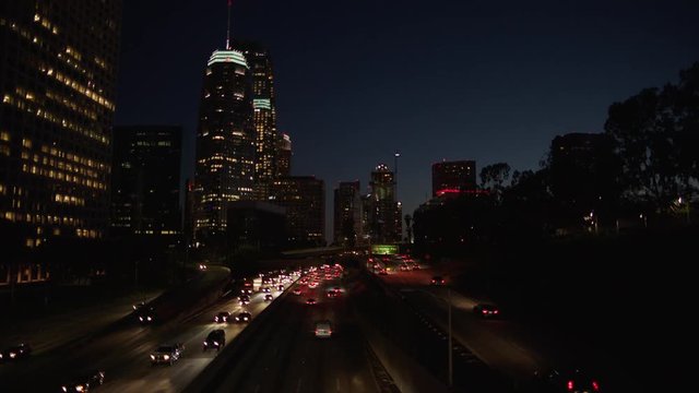 Freeway traffic in downtown Los Angeles at night. Evening Rush Hour Traffic. 4K