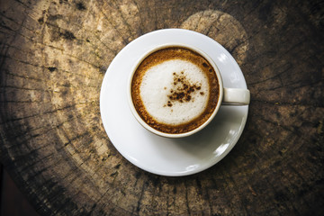 Capuccino on old wood table.