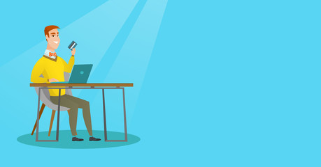 Young caucasian man paying online by credit card.