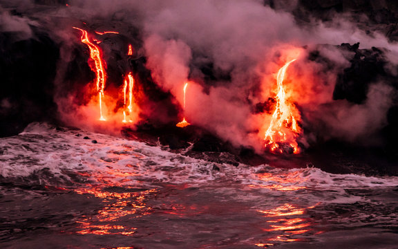Lava is flowing from volcano Kīlauea to Pacific ocean at night