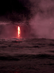 Lava is flowing from volcano Kīlauea to Pacific ocean at night