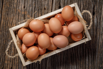 Brown eggs in wooden box on wooden table, Chicken Egg