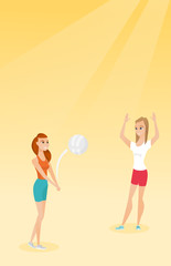 Fototapeta na wymiar Two caucasian women playing beach volleyball.