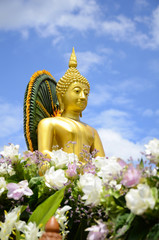 Fototapeta premium Buddha statue on bright sky background.