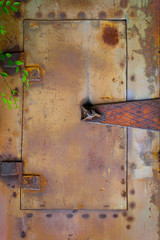 Steampunk background. Painted rusty metal door. 